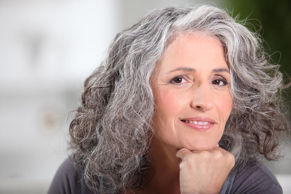 Attractive gray-haired woman with smooth skin